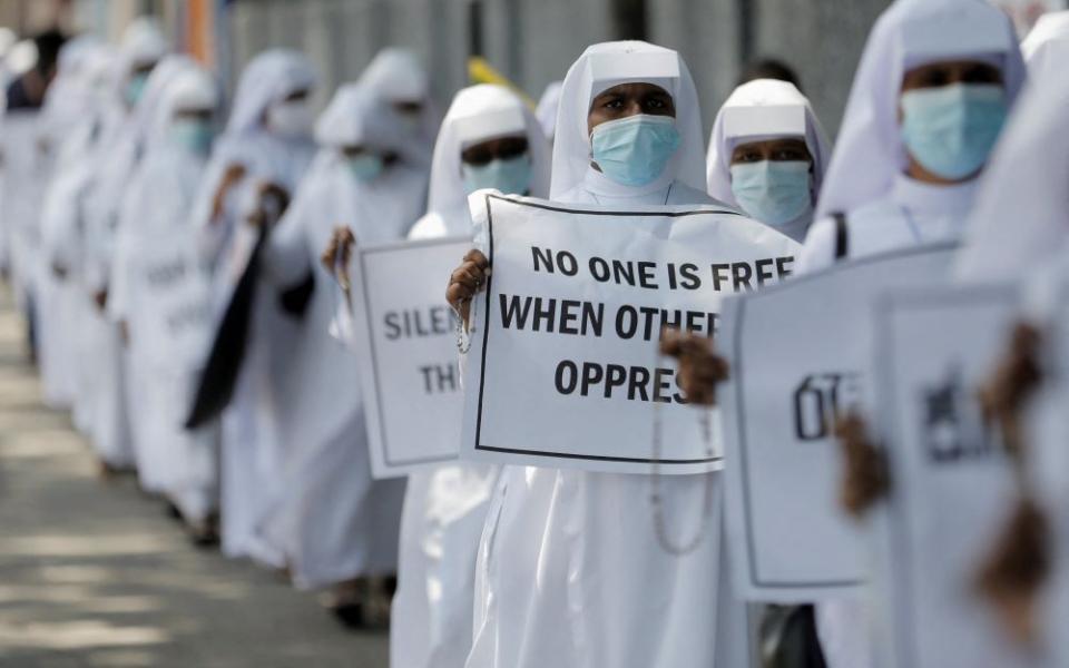 Nuns hold placards during a protest demanding Sri Lankan President Gotabaya Rajapaksa step down in Colombo April 5. Rajapaksa is trying to stabilize his government after protests prompted most of his Cabinet to resign. (CNS/Reuters/Dinuka Liyan)
