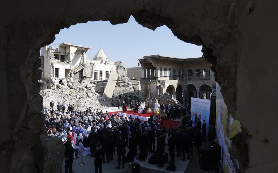 People gathered in bombed out church square with Pope Francis in Mosul, Iraq