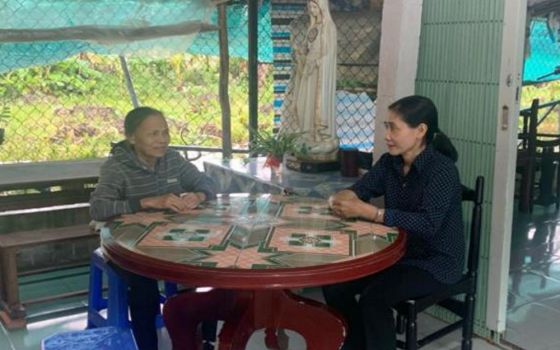 Sr. Mary Nguyen Thi My, left, meets with Sister Chuong of the Daughters of the Mother of God, about a report for a project on water purification. Since 2000, Sr. Mary Nguyen Thi My has worked with Vietnamese sisters, using her knowledge of English to help