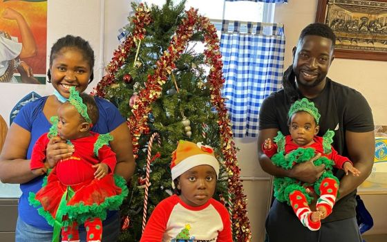 A refugee family from Haiti celebrates Christmas at a soup kitchen in Immokalee, Florida. The twins were born two weeks after the family arrived in the country. (Judy Dohner)