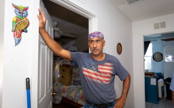 Luis Reyes, an employee of Catholic Charities of the Diocese of Venice, inspects damage to his home in Fort Meyers, Fla., Oct 5, after Hurricane Ian brought at least 3 inches of rain into the residence Sept. 28. (CNS/Tom Tracy)