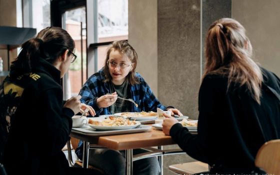 People displaced by the war in Ukraine eat a meal in St. Basil the Great High School in Ivano-Frankivsk in March. (CNS/Courtesy of the Archeparchy of Ivano-Frankivsk)