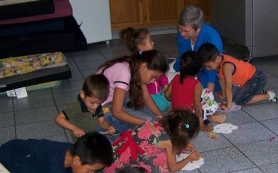 Sr. Rosemary Nicholson helps children make animal masks at Madre Asunta in Tijuana, Mexico. She has worked at Instituto Madre Asunta, a shelter for migrants across the border from San Diego, since summer 2018. (Courtesy of Rosemary Nicholson)