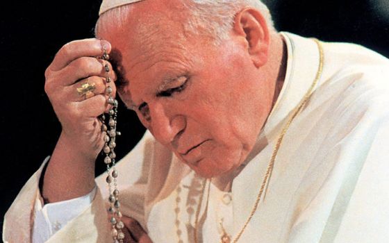 Pope John Paul II prays the rosary at Notre Dame du Chant d'Oiseau Church in Brussels in June 1995. (CNS/Catholic Press Photo)