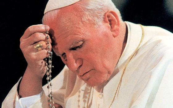 Pope John Paul II prays the rosary at Notre Dame du Chant d'Oiseau Church in Brussels in June 1995. (CNS/Catholic Press Photo)