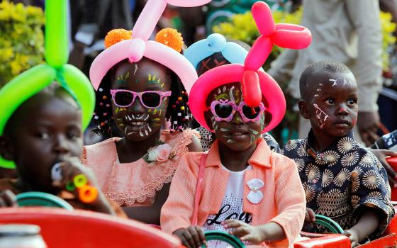 Children in Nairobi, Kenya, ride on a makeshift train Dec. 25, 2019, during Christmas celebrations. (CNS/Reuters/Njeri Mwangi)