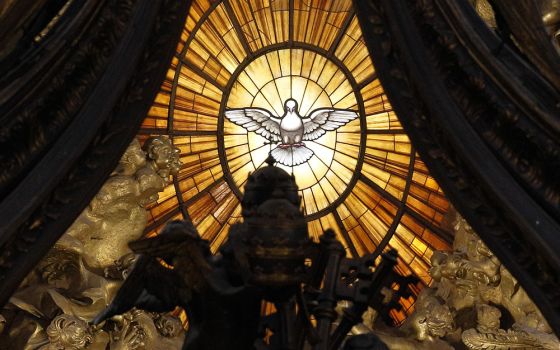 The Holy Spirit window is pictured through the Baldacchino in St. Peter's Basilica at the Vatican. (CNS/Paul Haring)
