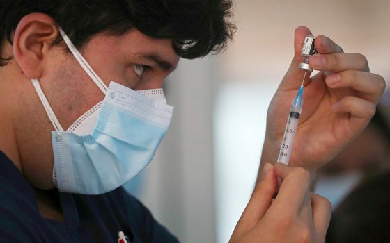 A health care worker at the Posta Central Hospital in Santiago, Chile, prepares a dose of the Pfizer/BioNtech COVID-19 vaccine Dec. 24 amid the coronavirus pandemic. (CNS/Reuters/Ivan Alvarado)