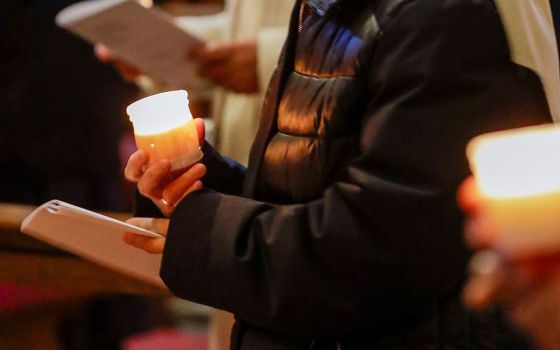 Nuns hold candles as Pope Francis celebrates Mass marking Candlemas and the World Day for Consecrated Life in St. Peter's Basilica Feb. 2, 2021, at the Vatican. (CNS/Andrew Medichini, Reuters pool)