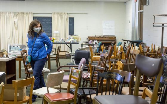 A woman in Farmington Hills, Michigan, browses items March 19 at the estate sale held by the Sisters of Mercy as they clean out their former convent. (CNS/Jim West)