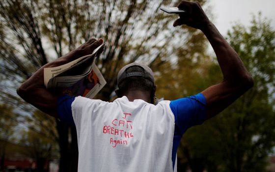 A man in Boston wears a hand-lettered T-shirt reading "I Can Breathe Again" at a demonstration April 21, 2021, one day after jurors convicted former Minneapolis police officer Derek Chauvin of second-degree unintentional murder, third-degree murder and se