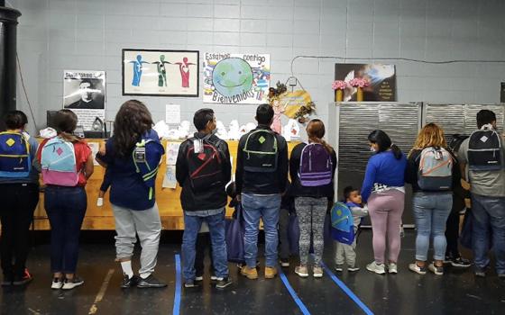 Mercy Srs. Terry Saetta, far left, and Patricia Mulderick, far right, pose for a photo May 7, 2021, at the "respite center" in McAllen, Texas, where they volunteered to help migrants.