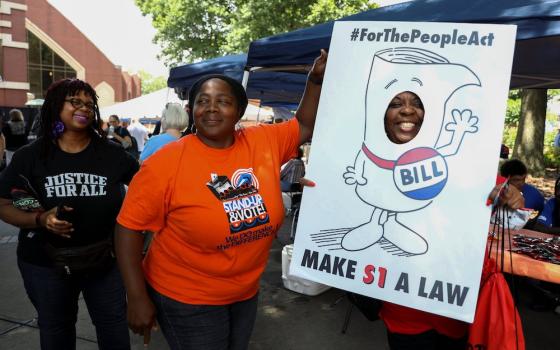 People in Atlanta advocate for the For the People Act on a June 21 stop on the Black Voters Matter organization's Freedom Ride for Voting Rights. Organizers said they planned the tour to recall the Freedom Rides, a series of protests against segregation b