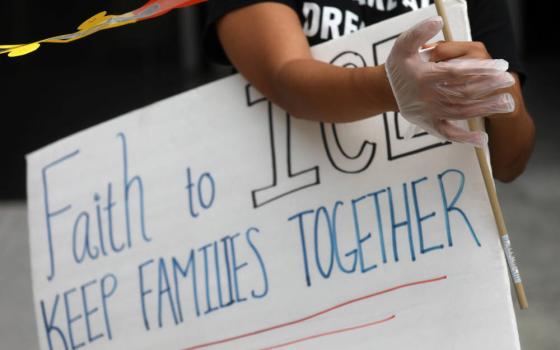 An immigration rights activist is seen outside U.S. Immigration and Customs Enforcement headquarters in Washington July 17, 2020. The agency announced July 9, 2021, that it will no longer detain most pregnant, nursing and postpartum women for deportation.