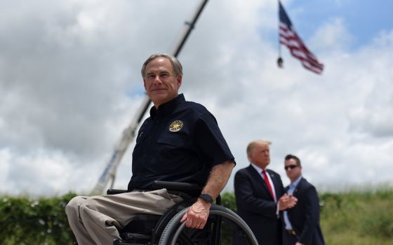 Texas Gov. Greg Abbott exits the stage with former President Donald Trump after a June 30 visit to an unfinished section of the wall along the U.S.-Mexico border in Pharr, Texas.