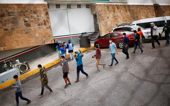 Migrants who were expelled from the United States and sent back to Mexico under Title 42 line up outside the National Institute of Migration building in Ciudad Juárez, Mexico, Aug. 13. (CNS/Reuters/Jose Luis Gonzalez)