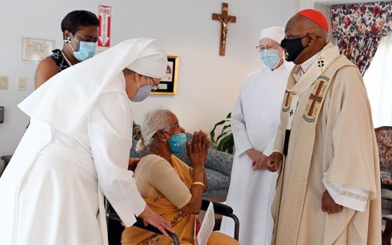 Washington Cardinal Wilton Gregory greets Mary Nathan, a resident of the Little Sisters' Jeanne Jugan Residence in Washington, after celebrating Mass on Aug. 14 to mark the 150th anniversary of the Little Sisters of the Poor in the nation's capital.