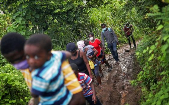 Haitian migrants walk through the forest in Tuxtla Chico, Mexico, Sept. 16 as part of a group of thousands of migrants who were heading to the U.S. border. (CNS/Reuters/Edgard Garrido)