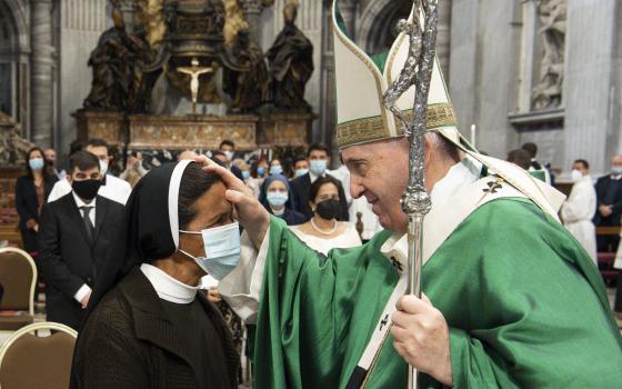 Pope Francis blesses Sister Gloria Cecilia Narváez Argot, a member of the Franciscan Sisters of Mary Immaculate, at the end of Mass in St. Peter's Basilica at the Vatican Oct. 10, 2021. The sister, a missionary from Colombia, was kidnapped in Mali in 2017