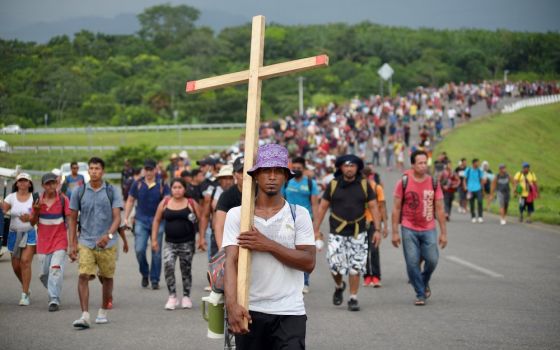 Migrants from Central America and Haiti walk in a caravan Oct. 25 near Huehuetan, Mexico. People were headed to Mexico City where they planned to apply for asylum and refugee status. (CNS/Reuters/Jacob Garcia)