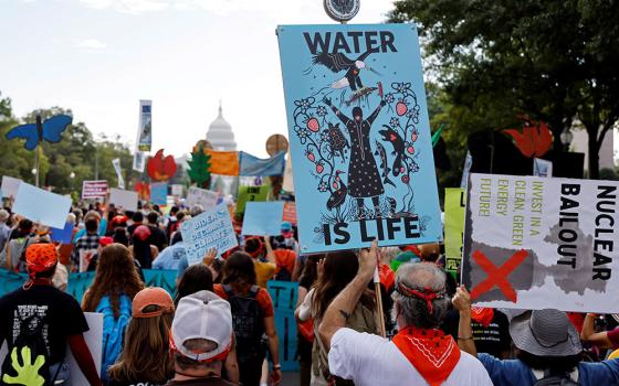 Environmental activists march to the U.S. Capitol during a climate change protest Oct. 15 in Washington. (CNS/Reuters/Jonathan Ernst)