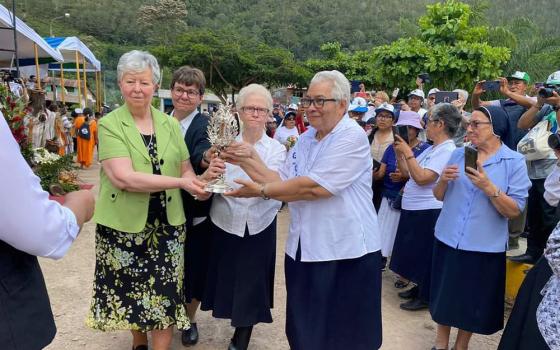 During the beatification ceremony for Sr. María Agustina Rivas López — affectionately known as Aguchita — on May 7 in La Florida, Peru, members of the Congregation of Our Lady of Charity of the Good Shepherd carry a reliquary containing bones of Aguchita. From left are Srs. Ellen Kelly, outgoing congregational leader; Mirjam Beike, new councilor; Yvette Arnold, procurator general; and Maria Susana Franco, outgoing vicar general. (Courtesy of Yvette Arnold)