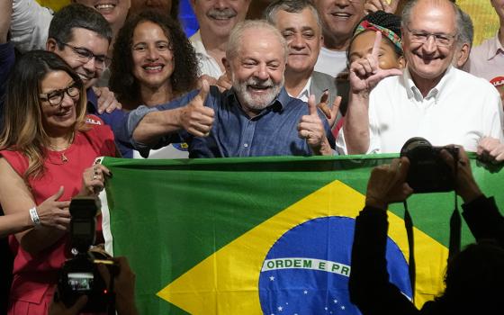Former Brazilian President Luiz Inácio Lula da Silva celebrates with his wife Rosangela Silva, left, and running mate Geraldo Alckmin, right, after defeating incumbent Jair Bolsonaro in a presidential run-off to become the country's next president, Oct. 30 in São Paulo, Brazil. (AP photo/Andre Penner)