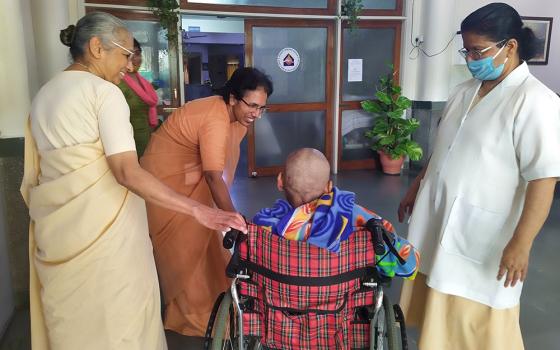 Holy Cross sisters welcome a new patient to Shanti Avedna Sadan in New Delhi. Standing from left: Holy Cross Srs. Alexia Pullooruthukkariyil, Tabitha Joseph and Felcy Mullor (Jessy Joseph)