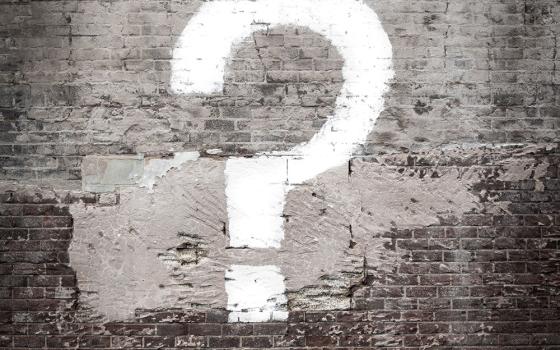 Question mark painted on a brick wall (Unsplash/Matt Walsh)