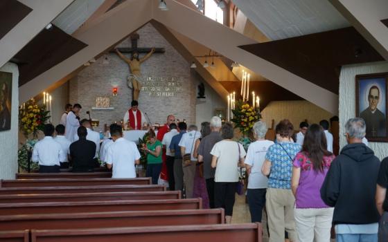 Delegates on the 2022 Roses in December trip line up for Communion on Nov. 30 at the Hospital Divina Providencia chapel in San Salvador, El Salvador, the hospital chapel where St. Óscar Romero was assassinated in 1980. (Courtesy of the SHARE Foundation)