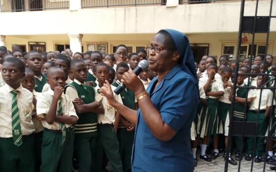 Sr. Bibiana Emenaha of the Daughters of Charity of St. Vincent de Paul speaks to students in February 2019 at a rural school in Edo, Nigeria, on the dangers of trafficking. (CNS/Courtesy of the Committee for the Support of Dignity of Women)