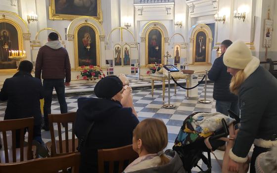 Ukrainian congregants gather for recent Sunday afternoon services at Dormishin Mother of God, a Ukrainian Catholic parish near Warsaw's Old Town. The church has become a center of gathering for Ukrainian refugees now living in Warsaw, Poland. "They look to God for help," said Basilian Fr. Peter Kushka, a priest at the church. "They are afraid." (GSR photo/Chris Herlinger)
