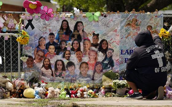 A mourner stops to pay his respects at a memorial at Robb Elementary School June 9 in Uvalde, Texas. The memorial was created to honor the two teachers and 19 students killed in a mass shooting at the school on May 24. (AP/Eric Gay, File)