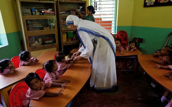 A member of the Missionaries of Charity interacts with the children of a kindergarten Aug. 30, 2016, inside the Nirmala Shishu Bhavan, a home for orphaned, destitute and abandoned children in Kolkata, India. (CNS/Reuters/Rupak De Chowdhuri)