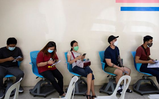 People wait for a booster dose of the COVID-19 vaccine in Manila, Philippines, on Jan. 5. (CNS/Reuters/Eloisa Lopez)