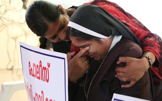 A nun is consoled during a Sept. 13, 2018, protest in Cochin, India. The protest was to demand justice after a former religious superior accused Bishop Franco Mulakkal of Jalandhar of raping her. A court acquitted Mulakkal of all charges Jan. 14. (CNS)