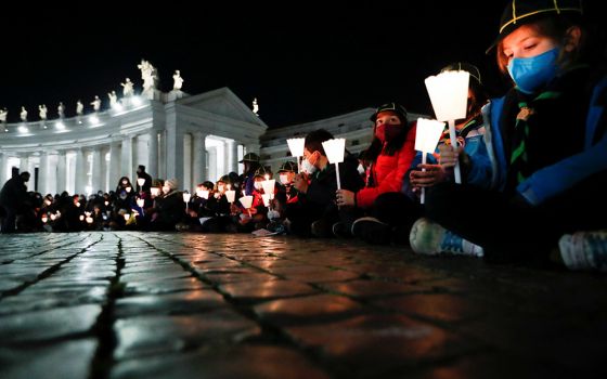 People gather to pray for peace in Ukraine March 2 in St. Peter's Square at the Vatican. (CNS/Reuters/Remo Casilli)