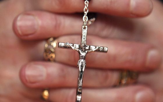 A woman holds a rosary during a March 21, 2010, Mass at a church in Armagh, Northern Ireland. (CNS/Reuters/Cathal McNaughton)