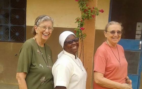 Three Marianite sisters (from left), Suellen Tennyson, Pascaline Tougma and Pauline Dourin, are pictured in an undated photo near the clinic where they serve in Yago, Burkina Faso. (CNS/Courtesy of the Marianites of the Holy Cross)