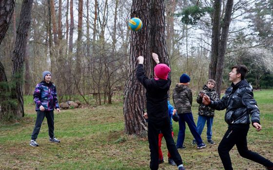 Ukrainian children from a group home for orphans in Zhytomyr, Ukraine, play in the yard of the motherhouse of the Congregation of the Sisters of the Angels April 20 in Konstancin-Jeziorna, Poland. (CNS/Adrian Kowalewski)