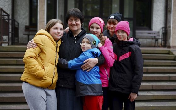 Sr. Antonina Sinicka, a member of the Congregation of Sisters of the Angels, poses with five of the children from a group home in Zhytomyr, Ukraine, at the congregation's motherhouse in Konstancin-Jeziorna, Poland, on April 20. (CNS/Adrian Kowalewski)
