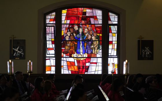 A stained-glass window depicting the descent of the Holy Spirit upon Mary and the apostles is seen during a confirmation Mass May 5 at Holy Family Church in Queens, New York. (CNS/Gregory A. Shemitz)