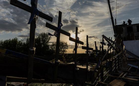 Crosses attached to a destroyed bridge in Irpin, Ukraine, on May 16 (CNS/Reuters/Jorge Silva)