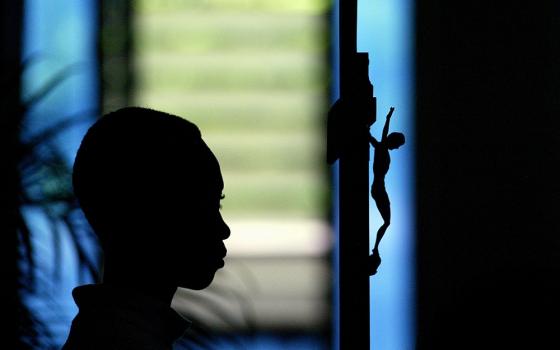 An altar server is pictured in a file photo holding a crucifix during Mass at a church in Port-au-Prince, Haiti.