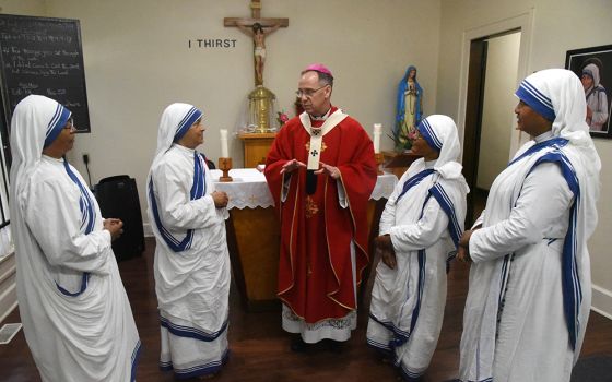 Archbishop Charles Thompson of Indianapolis speaks Sept. 21 with four Missionaries of Charity after celebrating Mass for them at the congregation's Our Lady of Peace Convent, located in one of the city's poorest neighborhoods. The sisters are, from left, 