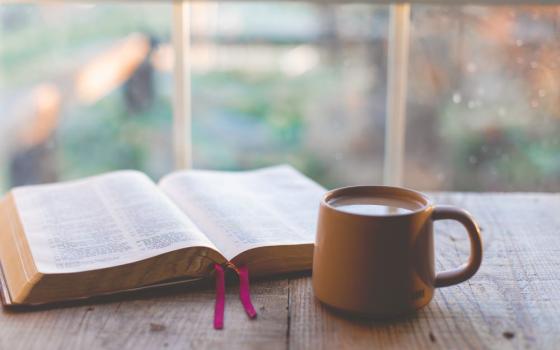 Bible and coffee cup on table