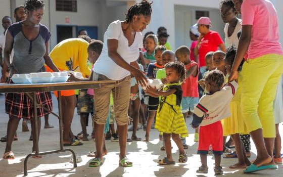 Children in Haiti receive food aid.