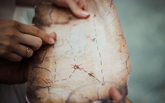 hands hold treasure map
