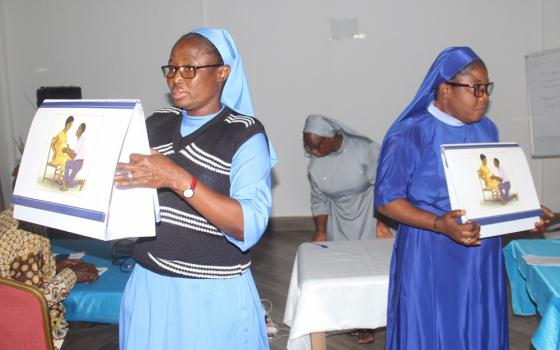 Mary Immaculate Sr. Stephany Ayomah, left, and Daughter of Mary Mother of Mercy Sr. Agatha Chiamaka, a midwife at Good Shepherd Health Centre at Tuna in the Damongo Diocese, demonstrate how to use flipcharts during one of a June trainings in Tamale, Ghana. (Courtesy of Francis Monnie)
