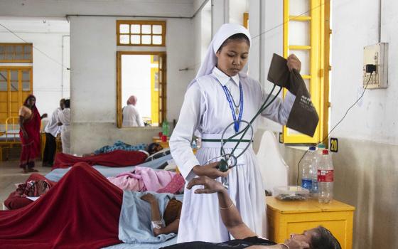 Sister Falguni, a member of the Associates of Mary Queen of Apostles and a student at Kumudini Nursing College in Mirzapur, Bangladesh, attends to a patient. (Uttom S. Rozario)